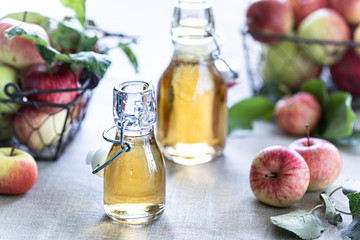 Apple vinegar. Bottle of apple organic vinegar or cider on wooden background. Healthy organic food.