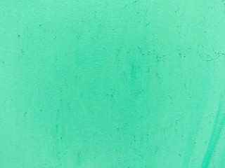 Fototapeta na wymiar Green pastel painted cement wall. Abstract grunge texture background. Copy space, empty template for text