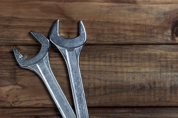 set of wrenches on a wooden background, place for an inscription	