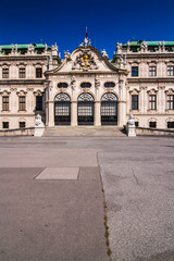 Fototapeta na wymiar Beautiful view of Upper Belvedere Palace with statues. antique facade with carved elements, figures and bas-relief. Low angle view