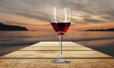 Red wine glass on wooden desk