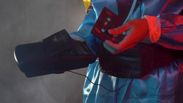 Using a portable cassette player by inserting a tape to listen to music.