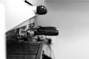 Barista in a coffee shop brews coffee in a coffee machine