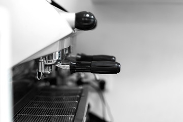 Fototapeta na wymiar Barista in a coffee shop brews coffee in a coffee machine