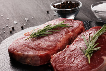 Steak raw. Barbecue Rib Eye Steak or rump steak on dark rustic table