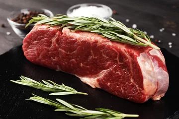 Fototapeten Steak raw. Barbecue Rib Eye Steak or rump steak on dark rustic table © beats_