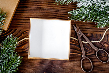 packaging christmas gifts in boxes on wooden background top view