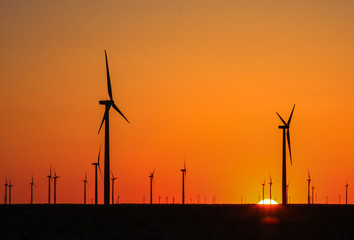 Wind Turbines At Sunset