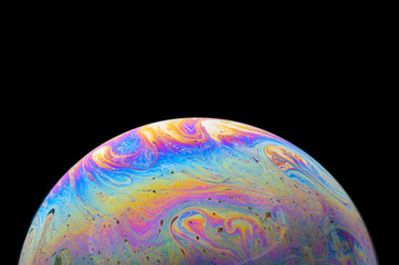 Abstract Soap bubble macro photo with black background look like planet
