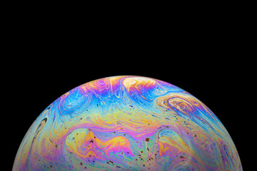 Abstract Soap bubble macro photo with black background look like planet