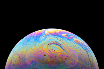Abstract Soap bubble macro photo with black background look like planet