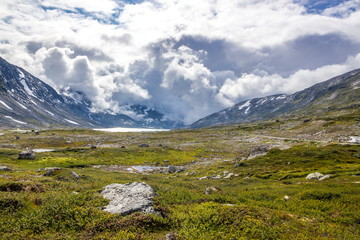 Naklejka na ściany i meble storm clouds over mountain road in Norway