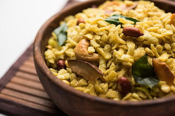 Jada Poha Namkeen Chivda / Thick Pohe Chiwda is a jar snack with a mix of sweet, salty and nuts flavours, served with tea. selective focus