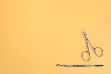 Top view of manicure and pedicure equipment on yellow background. Beauty, care and fashion concept....