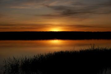 sunset on the river with reflection in the water