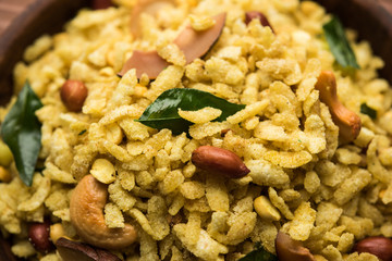 Jada Poha Namkeen Chivda / Thick Pohe Chiwda is a jar snack with a mix of sweet, salty and nuts flavours, served with tea. selective focus