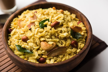 Jada Poha Namkeen Chivda / Thick Pohe Chiwda is a jar snack with a mix of sweet, salty and nuts flavours, served with tea. selective focus