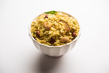 Jada Poha Namkeen Chivda / Thick Pohe Chiwda is a jar snack with a mix of sweet, salty and nuts flavours, served with tea. selective focus