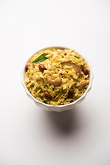 Jada Poha Namkeen Chivda / Thick Pohe Chiwda is a jar snack with a mix of sweet, salty and nuts flavours, served with tea. selective focus