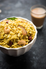 Jada Poha Namkeen Chivda / Thick Pohe Chiwda is a jar snack with a mix of sweet, salty and nuts flavours, served with tea. selective focus