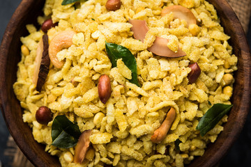 Jada Poha Namkeen Chivda / Thick Pohe Chiwda is a jar snack with a mix of sweet, salty and nuts flavours, served with tea. selective focus