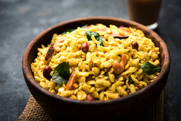 Jada Poha Namkeen Chivda / Thick Pohe Chiwda is a jar snack with a mix of sweet, salty and nuts flavours, served with tea. selective focus