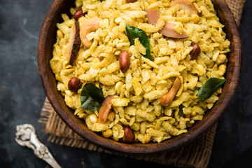 Jada Poha Namkeen Chivda / Thick Pohe Chiwda is a jar snack with a mix of sweet, salty and nuts flavours, served with tea. selective focus