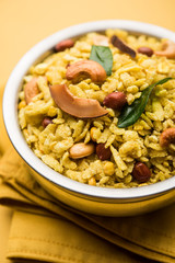 Jada Poha Namkeen Chivda / Thick Pohe Chiwda is a jar snack with a mix of sweet, salty and nuts flavours, served with tea. selective focus