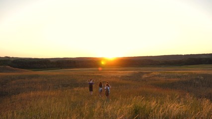 father carries a little daughter on his shoulders, a happy family travels in park. Family with children travels on the plains and mountains. father, mother daughter tourists. teamwork travelers.