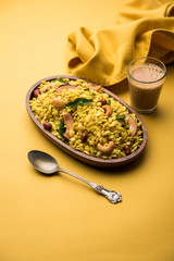 Jada Poha Namkeen Chivda / Thick Pohe Chiwda is a jar snack with a mix of sweet, salty and nuts flavours, served with tea. selective focus