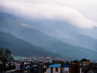 View over the Roofs of the City of Dali in Yunnan Province (China). With the mountains in the...