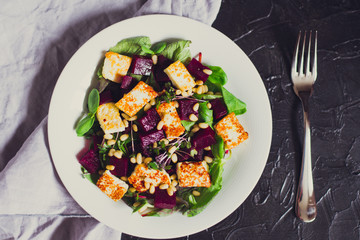 beetroot salad with grilled cheese and pine nuts, top view