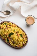 Jada Poha Namkeen Chivda / Thick Pohe Chiwda is a jar snack with a mix of sweet, salty and nuts flavours, served with tea. selective focus
