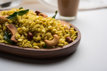 Jada Poha Namkeen Chivda / Thick Pohe Chiwda is a jar snack with a mix of sweet, salty and nuts flavours, served with tea. selective focus