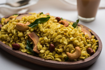 Jada Poha Namkeen Chivda / Thick Pohe Chiwda is a jar snack with a mix of sweet, salty and nuts flavours, served with tea. selective focus
