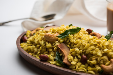 Jada Poha Namkeen Chivda / Thick Pohe Chiwda is a jar snack with a mix of sweet, salty and nuts flavours, served with tea. selective focus