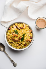 Jada Poha Namkeen Chivda / Thick Pohe Chiwda is a jar snack with a mix of sweet, salty and nuts flavours, served with tea. selective focus