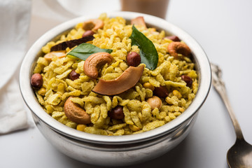 Jada Poha Namkeen Chivda / Thick Pohe Chiwda is a jar snack with a mix of sweet, salty and nuts flavours, served with tea. selective focus