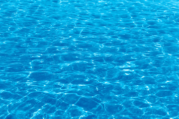 Fototapeta na wymiar Ocean or pool blue water abstract background with sun reflection.