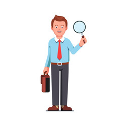 Business man holding magnifying glass in hands