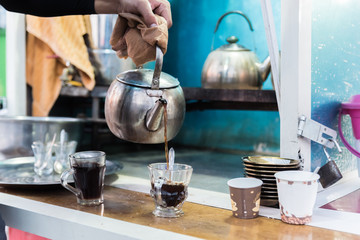 Hand pours tea © focusandblur