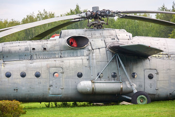 Old military helicopter painted in gray color close-up.