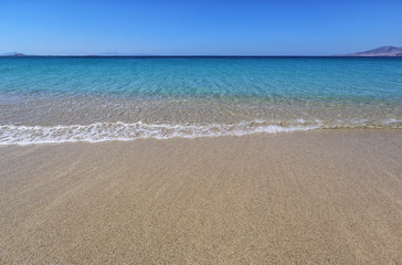Fototapeta na wymiar Clear turquoise sea and spotless beach of Aegean Sea at Agios Prokopios, Naxos, Greek Islands