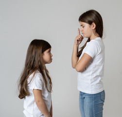 Young sisters having an argument, Older sister shouting at younger sibling
