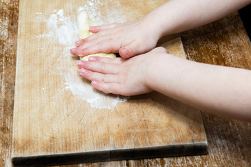 Fototapeta na wymiar preparation of the dough to make the gnocchi, made by a child