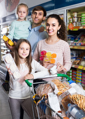  customers with children selecting sweet dairy products in hypermarket