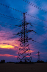 high-voltage  power lines at sunset.