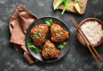 Grilled chicken thighs and bowl of rice