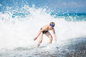 boy playing on the waves