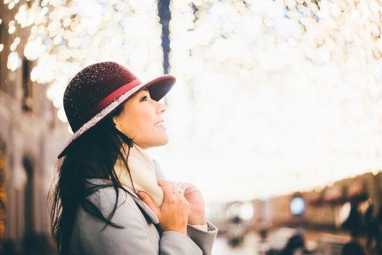 Girls in the festive city at the night. Christmas night. Night portrait of the girl in a winter city.